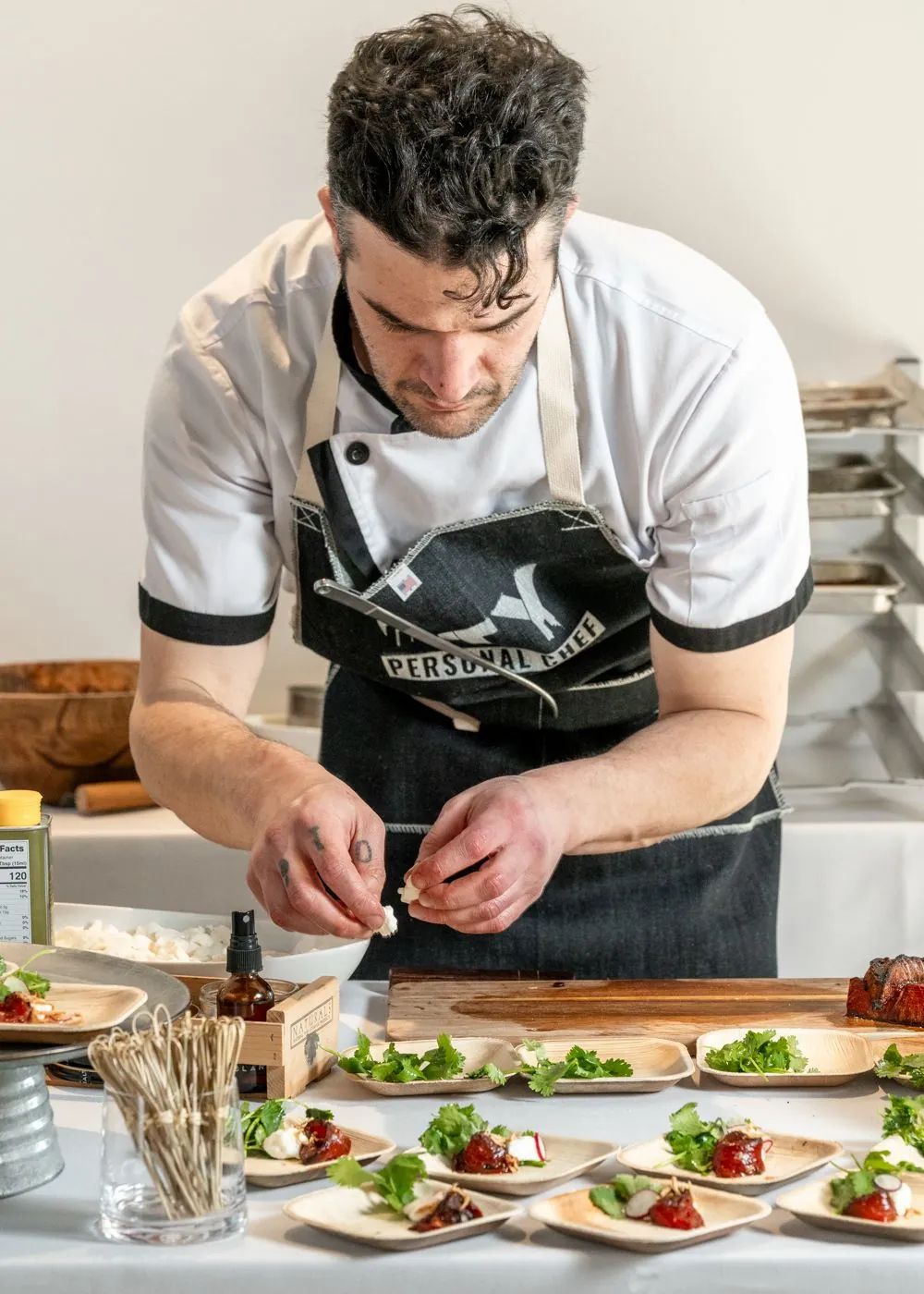 A chef plating courses at a Driven by Taste dinner