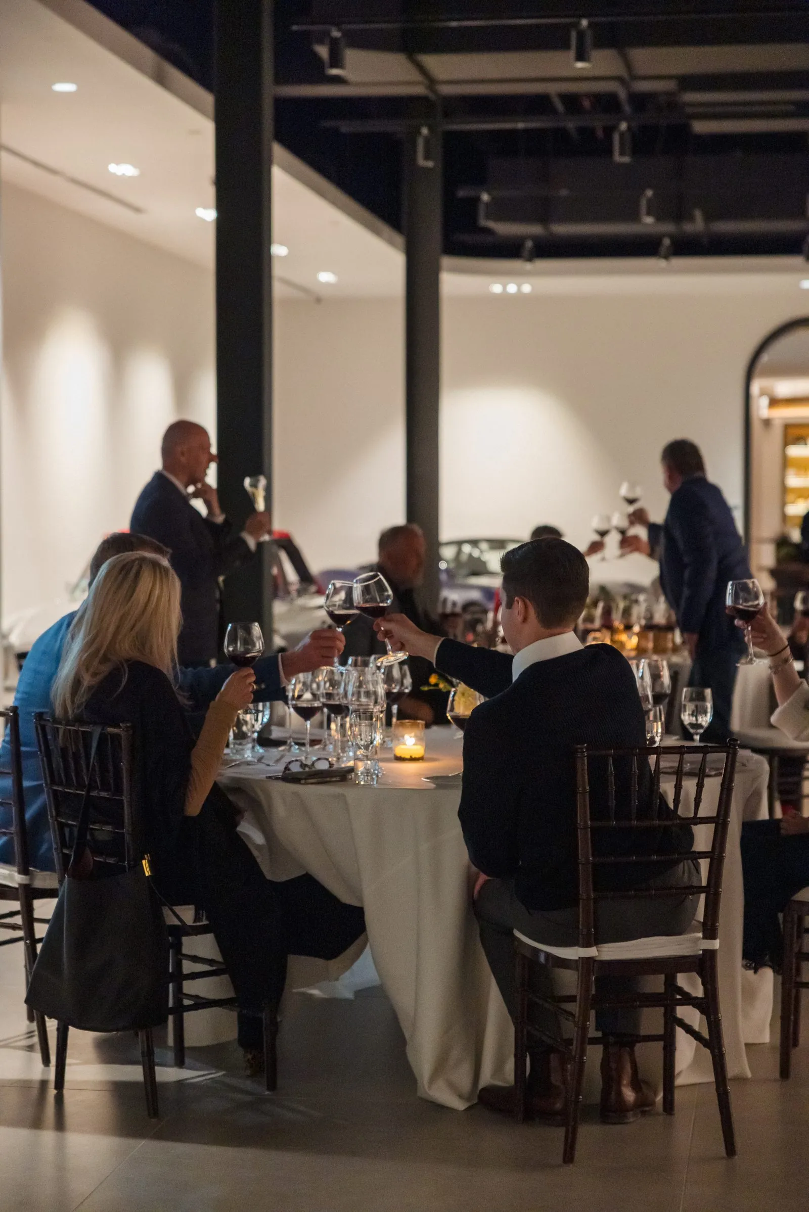 Guests raising a toast at a wine dinner among the Archive collection