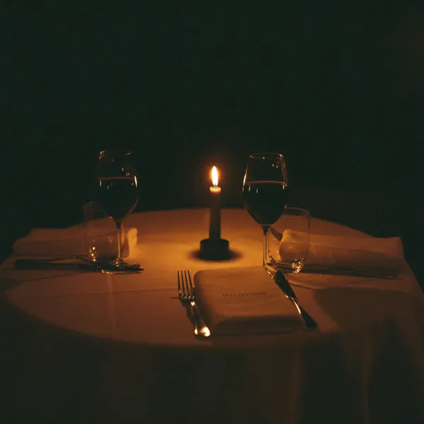 An intimate candlelit table setting, close and warm
