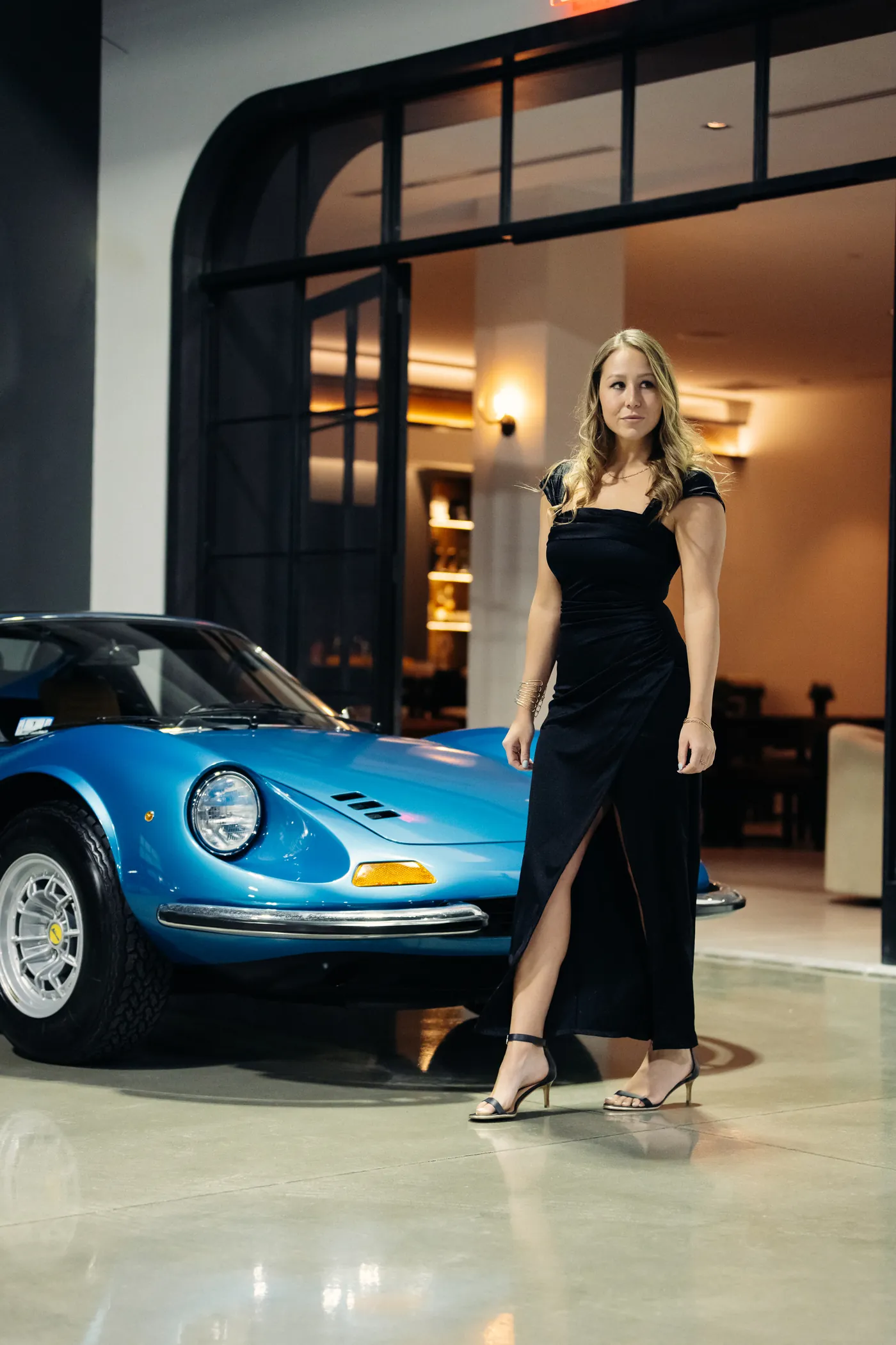 A member in the Archive gallery beside a collector Ferrari
