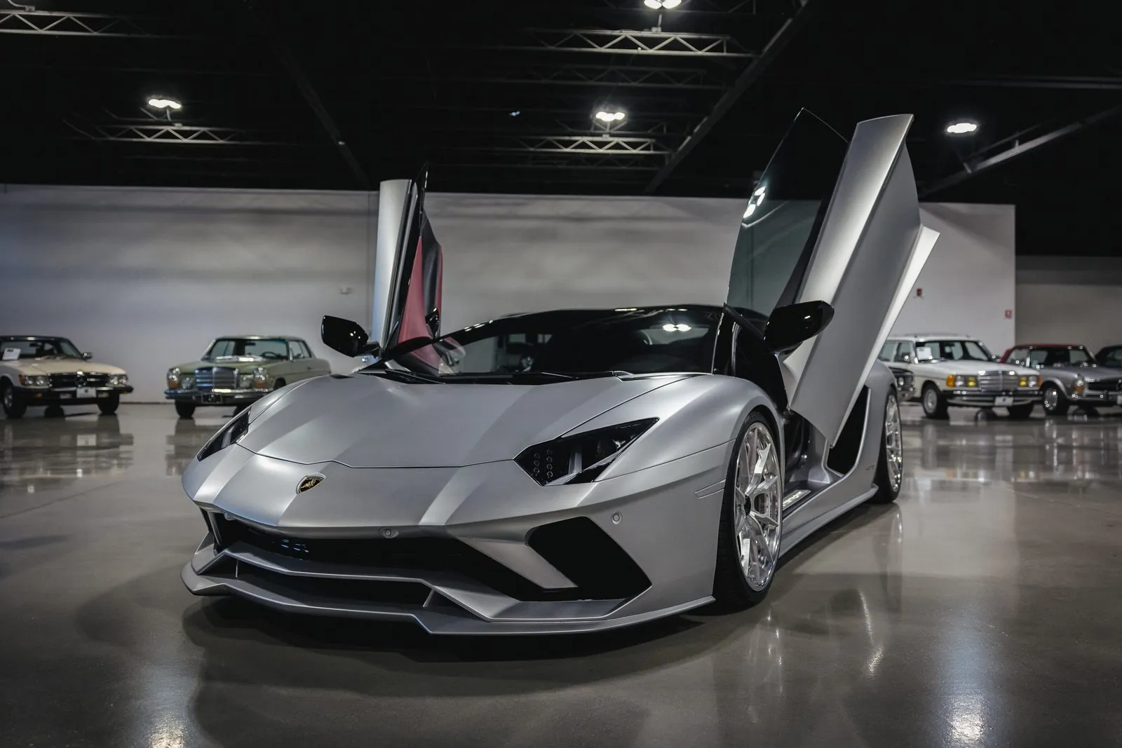 A Lamborghini with doors raised in the Archive showroom