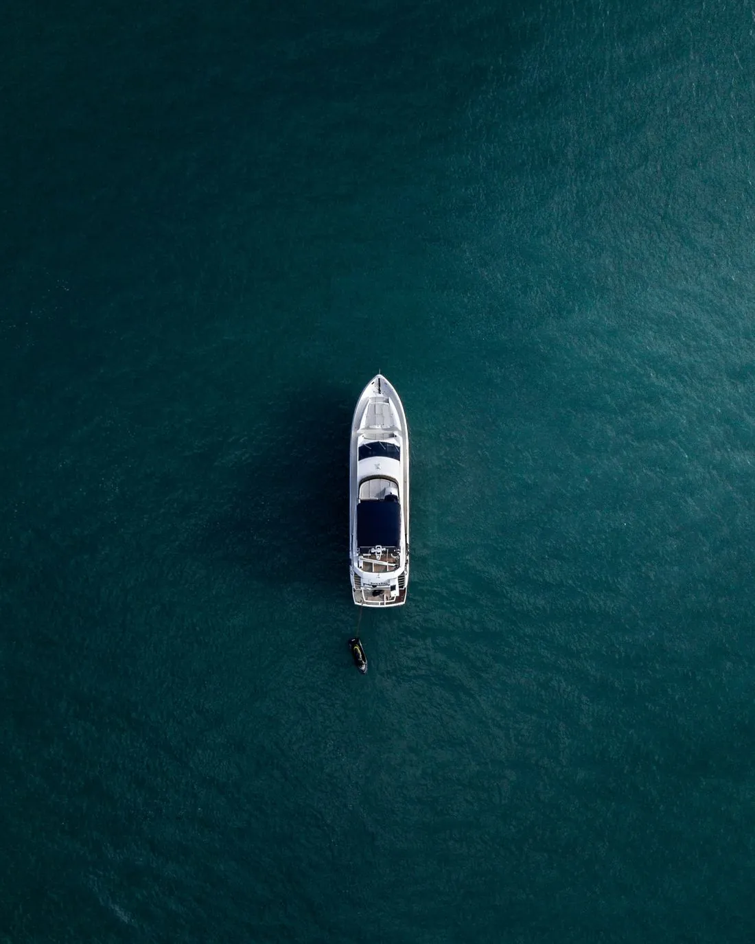 A yacht anchored on open water, from above
