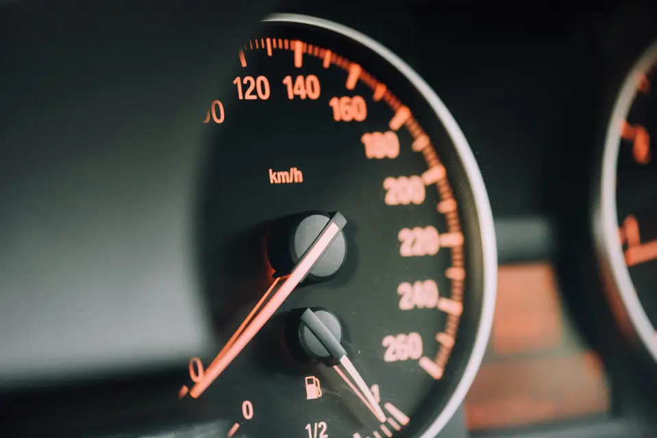 An analog speedometer close up
