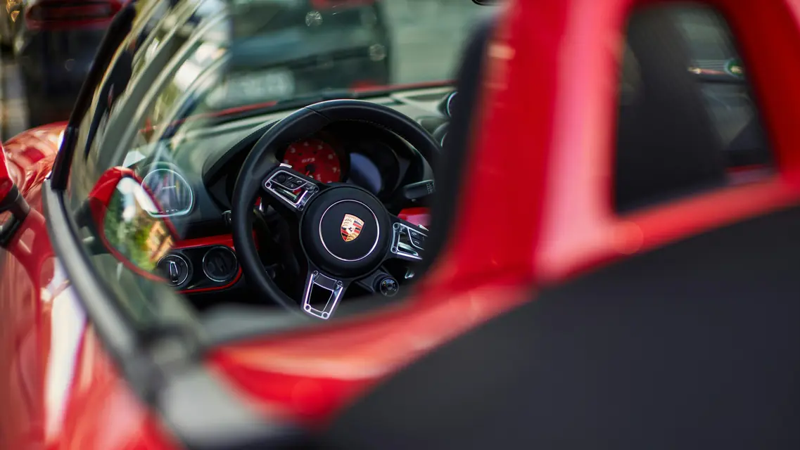 A wheel seen through sports car glass