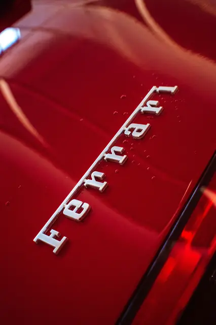A script badge on red paint