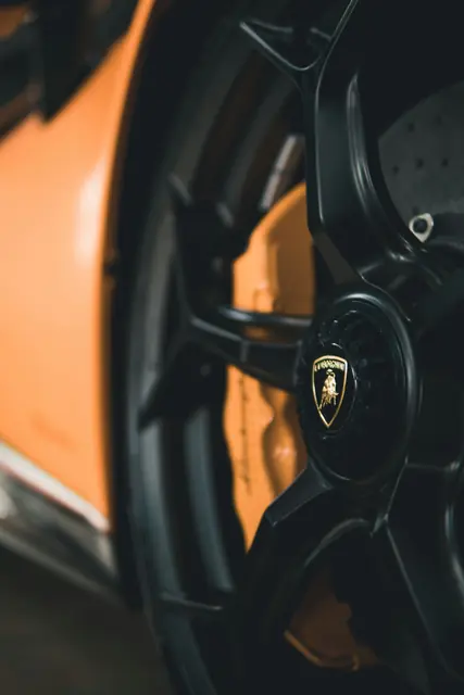 A steering wheel in a low lit cabin